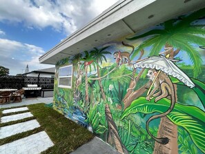 Completed in 2023 by a local artist, this unique, custom mural features a tropical paradise galore.