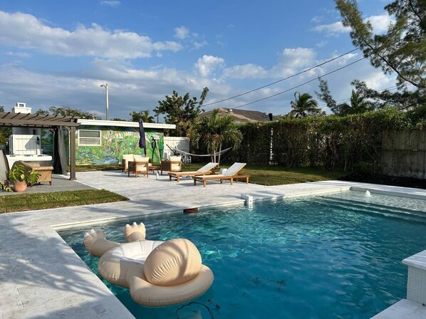 Completed in 2023, our oversized luxury pool comes with fountains, a waterfall and a unique, custom tropical mural on the back of the house. Enjoy this sliver of backyard paradise!