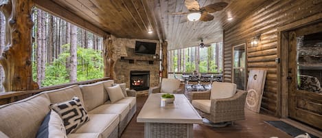 Relax on the large back patio featuring a smart TV over a gas fireplace.