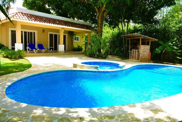 View of the pool jacuzzi (not heated)  charcoal bbq and patio.