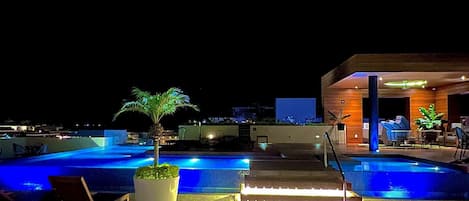 Rooftop infinity pool with 360 degree views at night