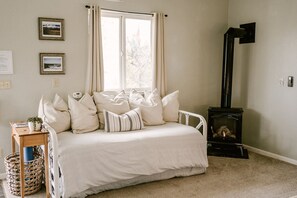 This daybed doubles as a sofa. Additional pull out bed below