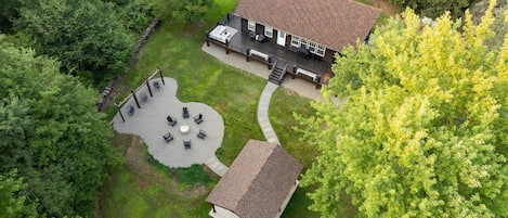 Beautiful aerial shot of the cabin and fun outdoor area.