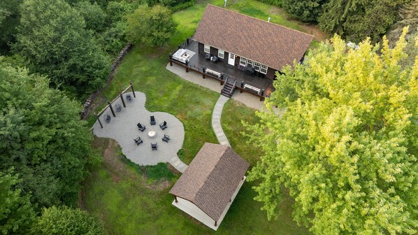 Beautiful aerial shot of the cabin and fun outdoor area.