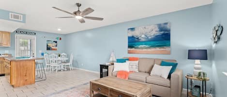 Bright and open living room/kitchen view. Queen sized sleeper sofa.