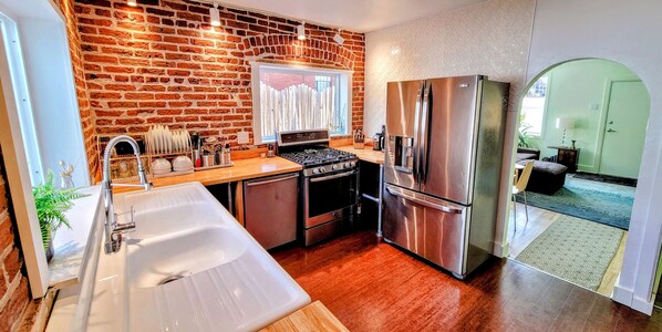 Beautiful kitchen w big windows and 130 yo exposed brick from the front range