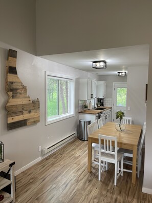 Dining area with large table, and 8 chairs