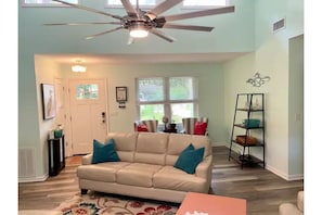 Living area with high ceilings, skylights and HUGE ceiling fan to keep you comfy