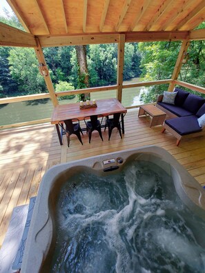 Spending time under the covered porch overlooking the lake in the Hot Tub