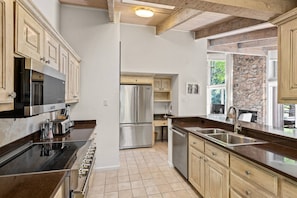 A large kitchen with high-end appliances and lots of of counter space is fully stocked to prepare great meals during your stay.
