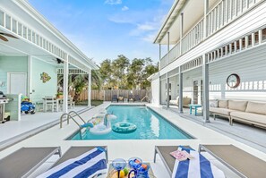 Pool with lounge area and outdoor kitchen