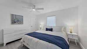 King bed in guest bedroom with 55" Smart TV