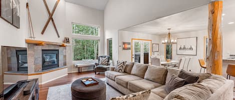 Living area features cozy furnishings, a gas fireplace, ceiling fan, and SmartTV.