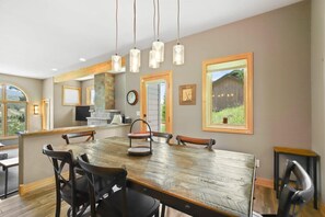 The view from the dining area highlights the close proximity between the living room and dining area and the open layout between the living, kitchen and dining spaces.