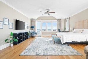 The bedroom boasts a breathtaking beach view, with large windows that allow for plenty of natural light to fill the room.