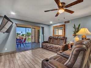 Roku TV with remote, ceiling fan and view of the lake. Very comfortable area.