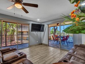 Roku TV with remote, ceiling fan and views of the lake