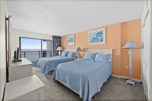 Two queen size beds with a flat-screen tv