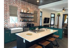 The kitchen with 8 comfortable counter stool spots.