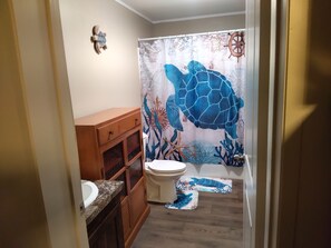 Master bathroom. Turtle on wall in both rooms, on bed, and shower curtain! 🐢