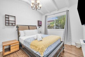 The second bedroom boasts a cozy queen bed and a TV for your entertainment needs.