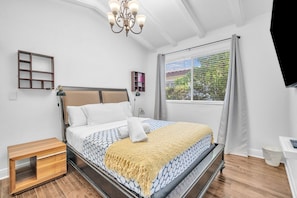 The second bedroom boasts a cozy queen bed and a TV for your entertainment needs.