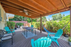 Experience the zen-like atmosphere of the backyard, which is rich with greenery, and boasts a small ping pong table, an inviting hammock, and numerous comfy chairs perfect for unwinding.