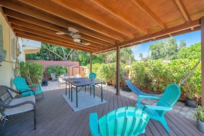 Experience the zen-like atmosphere of the backyard, which is rich with greenery, and boasts a small ping pong table, an inviting hammock, and numerous comfy chairs perfect for unwinding.