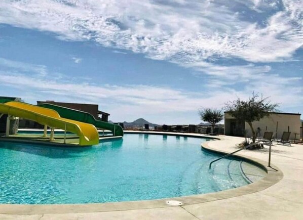 Dive into fun with the outdoor pool, featuring a thrilling waterslide that adds an extra splash of excitement. Perfect for both relaxation and play, this inviting pool area offers plenty of space for lounging and enjoying the sun. Whether you’re sliding into the water or simply soaking up the atmosphere, this pool provides a refreshing and entertaining experience for all.