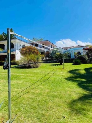 A private volleyball court is on the large garden grounds for fun day or night!