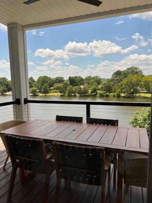 Spectacular outdoor dining views overlooking the lake on the main floor balcony