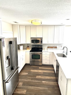 Full kitchen with stainless steel appliances