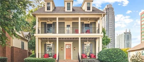 Experience the charm of a classic Victorian-style home with a spacious porch, balcony, and picturesque hillside location, creating an inviting and elegant residence.