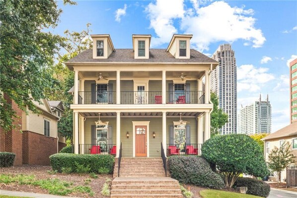 Experience the charm of a classic Victorian-style home with a spacious porch, balcony, and picturesque hillside location, creating an inviting and elegant residence.