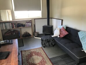 The cosy sitting room which has a futon for extra accommodation.