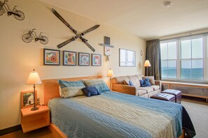 Queen bed and living room area of studio