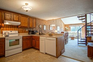 Dining and kitchen area with a spiral staircase to the second floor sleeping loft
