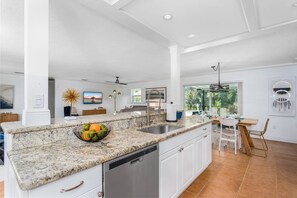 Open kitchen to everything!  Updated with stainless appliances...stocked with plenty of dishes & cookware