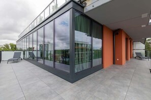 A sleek and modern exterior view of the property, showing its contemporary architecture and large balcony spaces.