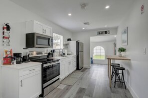 The Kitchen Contains Quartz Counters, Stainless Appliances and an Additional Dining/Seating Area