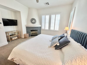 Bedroom with flatscreen TV, fireplace