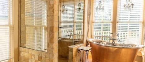 Immaculate master bathroom with walk-in shower with body jets and a copper soaking tub.