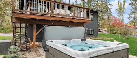 Relax in the hot tub in the back yard.