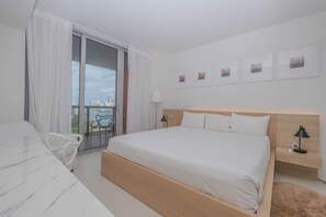 Sleep in luxury in the master bedroom with a king-size bed, Smart TV, and a private bathroom. Perfect for a peaceful retreat in Hallandale Beach.