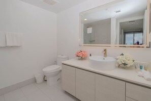 Indulge in modern bathrooms with LED-lit mirrors, hot water, and luxury amenities in this Beachwalk apartment near Hallandale Beach Oceanfront.