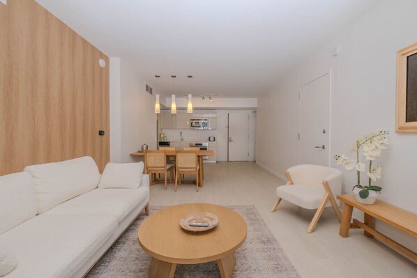 Relax in the modern and spacious living room of this luxurious 2-bedroom apartment at Beachwalk, Hallandale Beach. Perfect for enjoying movie nights on the 50'' Smart TV or simply unwinding after exploring Miami and Fort Lauderdale.