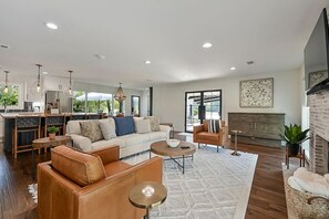 The huge living room includes a fireplace, and massive TV