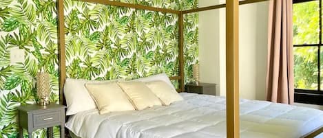 Guest Bedroom #2 with tropical themed gold canopy bed and palm leaf accent wall