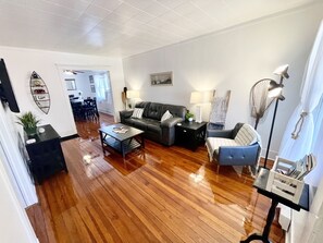 Beautiful, modern living room w/ restored, 1920 original hardwood flooring. 