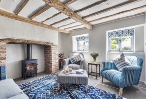 Hilltop Cottage, Wimborne: The stylish television room and snug with wood burning stove